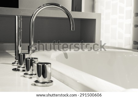 closeup faucet and bathtub in bathroom