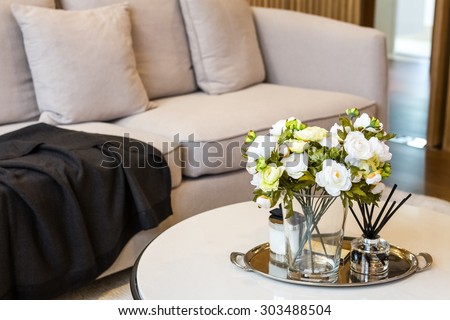 flowers in glass with incenses decorated in living room