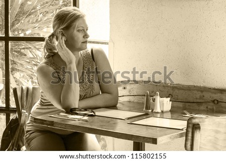 woman sitting in a cafe alone old style monochrome