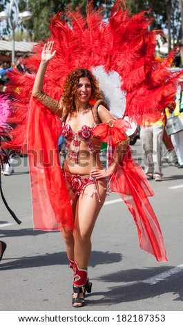 HOLON, ISRAEL - MARCH 16: Unidentified brazilian dancer woman walking through the streets of Holon during a procession on the feast of Purim carnival March 16, 2014 in Holon, Israel.
