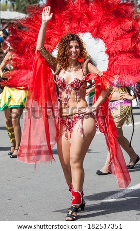 HOLON, ISRAEL - MARCH 16: Unidentified brazilian dancer woman walking through the streets of  Holon during a procession on the feast of Purim carnivall March 16, 2014 in Holon, Israel.