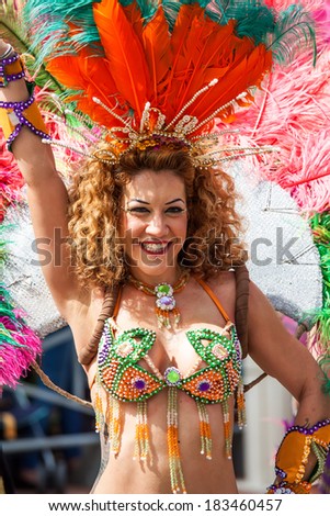 HOLON, ISRAEL - MARCH 16: Unidentified brazilian dancer woman walking l through the streets of  Holon during a procession on the feast of Purim carnivall March 16, 2014 in Holon, Israel.