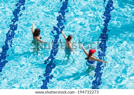 Wemen doing water aerobic in pool
