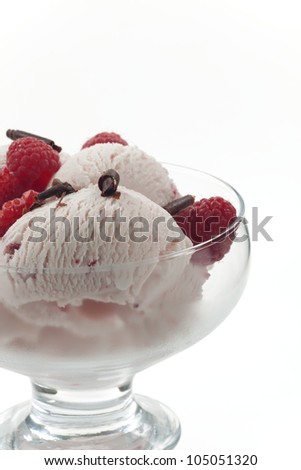 Closeup of delicious Fruit Ice Cream with fresh raspberries and chocolate swirls.