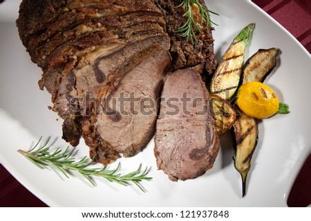 Herbed Rib Eye with grilled vegetables and two sauces.