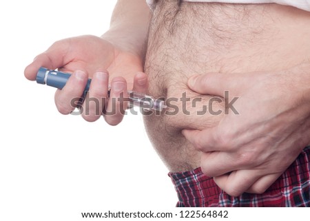 Overweight fat man with diabetes gets an insulin injection in abdomen area over white background.