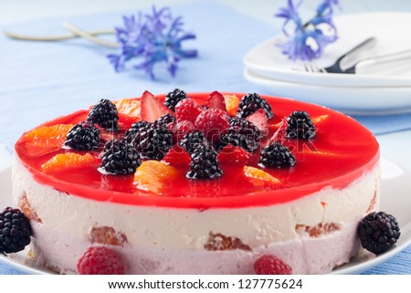 Fruit yogurt cake. Cream and yogurt based fruit filling topped with jelly. Raspberries, blackberries, stawberries, and oranges.