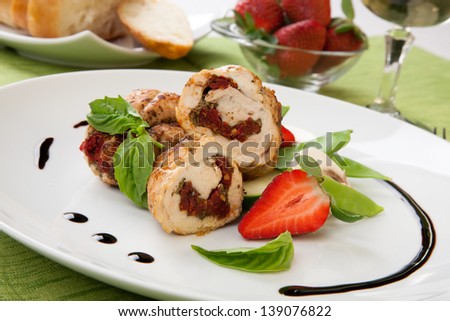 Sun-dried tomato and pesto stuffed chicken breast with vegetables, and fresh strawberry.