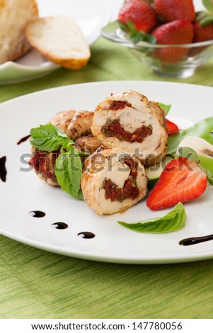 Sun-dried tomato and pesto stuffed chicken breast with vegetables, and fresh strawberry.