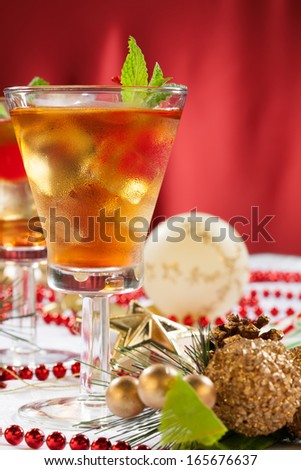 Glasses of Mint Manhattan cocktails surrounded with Christmas ornaments and decorations. Holiday cocktails series.