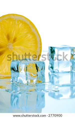 Two ice cubes melted in water and slice of lemon on reflection surface ready to be added to a cocktail