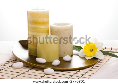 Spring relaxation spa set with candles and spring daffodil flower, suited for spa and healthy lifestyle usage.