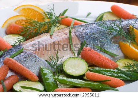 Organic whole trout cooked with vegetables served for dinner