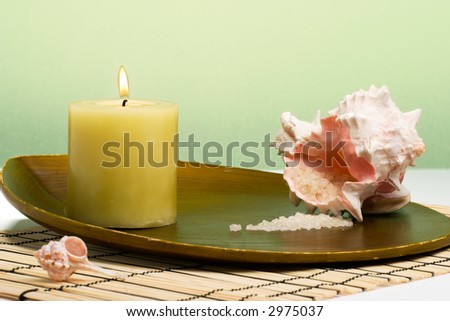 Aroma therapy with candle and seashells, suited for spa and healthy lifestyle usage.