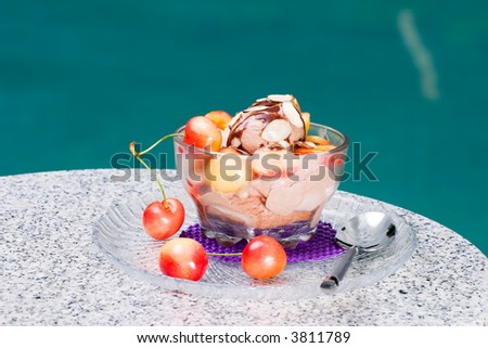 Closeup of delicious Chocolate Cherry Almond Sundae dessert served on pool side