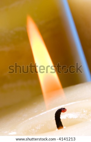 Closeup of lighting candle with burning match suited for relaxing ads usage
