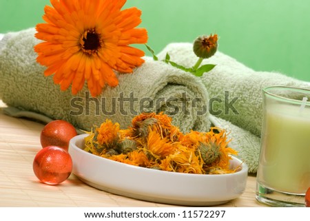 Fresh marigold spa set with fresh and dried flowers, aromatic oil balls, towels and arome candles. Best suited for relaxing and health commercials