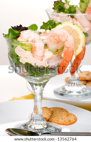 Delicious Prawn Cocktail.  Fresh jumbo shrimps, cream, lettuce leaves, lemon wedge and zesty sauce. Appetizer served in cocktail glass with whole wheat crackers.