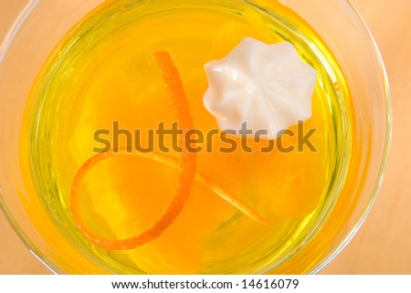 Closeup of delicious Champagne Orange jelly served with whipped cream and orange zest.
