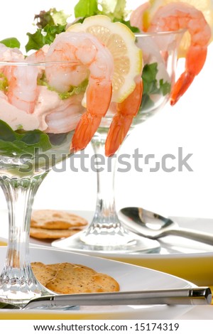 Delicious Prawn Cocktail.  Fresh jumbo shrimps, cream, lettuce leaves, lemon wedge and zesty sauce. Appetizer served in cocktail glass with whole wheat crackers.