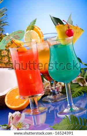 Mai Tai, Blue Hawaiian and Hurricane cocktails surrounded by tropical fruits. Most popular cocktails series.