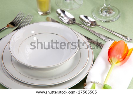 Fine food and wine spring table settings with fresh tulips