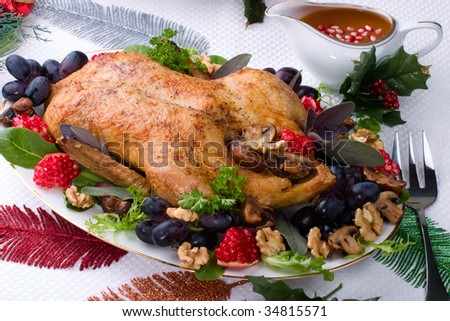 Garnished roasted duck on Christmas decorated table