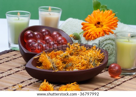 Fresh marigold spa set with fresh and dried flowers, aromatic oil balls, towels and arome candles. Best suited for relaxing and health commercials