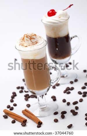 Two glasses of tasty Coffee Cocktails with whipped cream and maraschino cherry - Coffee Warmers series