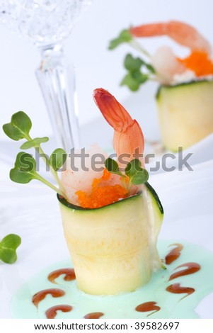 Two Zucchini Rolls with shrimps and seasoned capelin roe (Masago). Garnished with wasabi sauce.