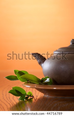 Clay teapot with Chinese green tea. Tea leaves.
