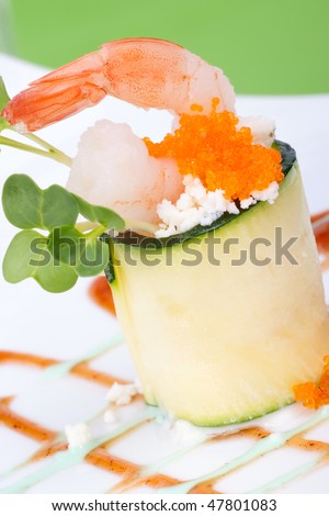 Zucchini Roll with shrimps and seasoned capelin roe (Masago). Garnished with wasabi sauce.