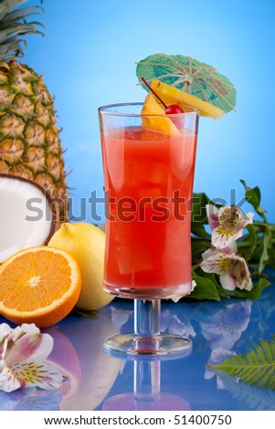 Hurricane cocktail surrounded by tropical fruits. Rum, passion fruit syrup and lime juice garnished with slice of pineapple and maraschino cherry. Most popular cocktails series.