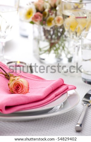 Romantic table settings. Arrangments with fresh roses and scented candles