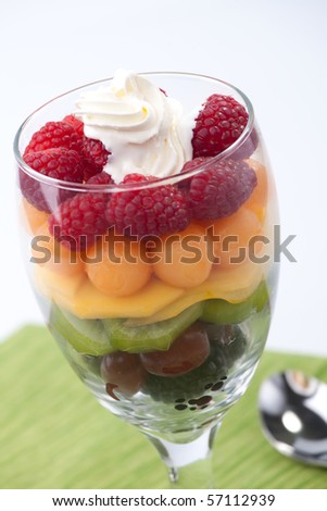 Serving of fresh rainbow fruit salad. Blackberries, red grapes, kiwi, mango, melon and raspberries.