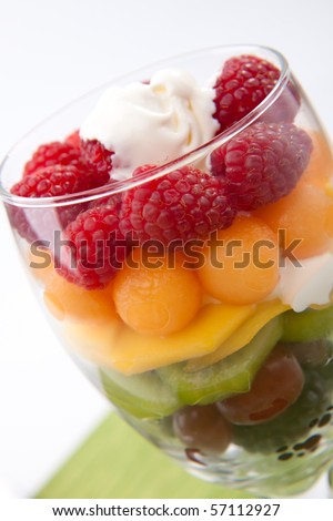 Serving of fresh rainbow fruit salad. Blackberries, red grapes, kiwi, mango, melon and raspberries.