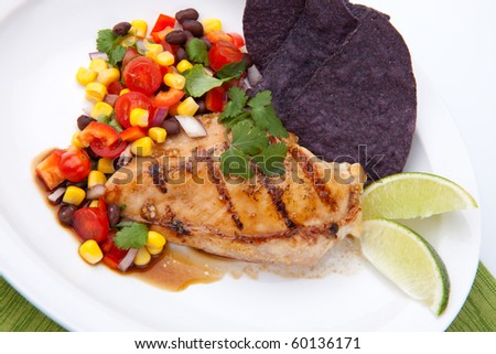 Grilled chicken breast with salsa - black beans, corn, tomatoes, chilli pepper, cilantro, red onion - with  blue corn tortilla chips.