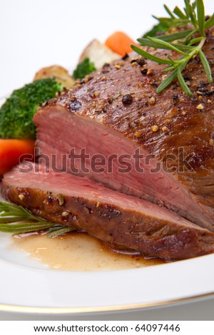 Roasted beef loin tri-tip, garnished with vegetables
