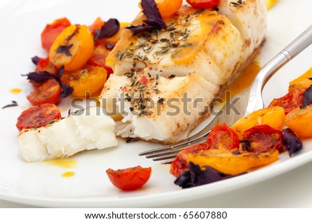 Pan fried halibut garnished with fennel seeds and spicy mustard sauce, served with fried cherry tomatoes salad with purple basil