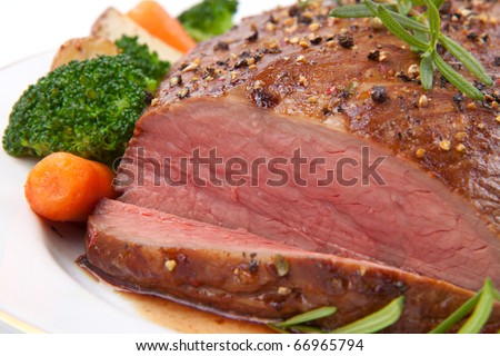 Roasted beef loin tri-tip, garnished with vegetables
