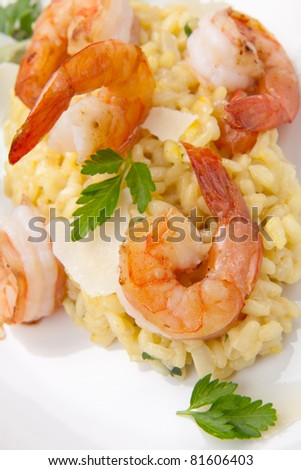 Plate of Shrimps Risotto garnished with fresh parsley and Parmesan cheese.