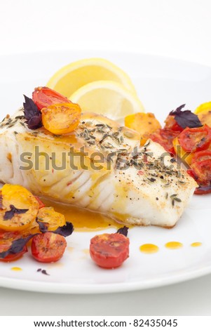 Pan fried halibut garnished with fennel seeds and spicy mustard sauce, served with fried cherry tomatoes salad with purple basil