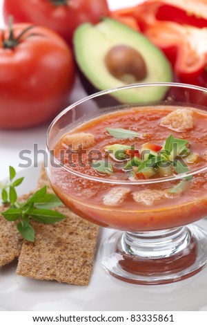 Closeup of bowl of delicious cold Gazpacho soup with cucumber - avocado salsa. Good summer time appetizer.