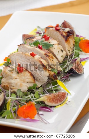 Margarita Chicken breast, grilled, over Micro Greens salad with edible flowers and black figs.