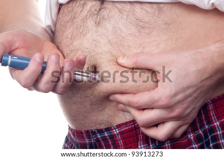 Overweight fat man with diabetes gets an insulin injection in abdomen area over white background.