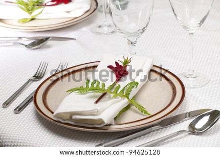 Exotic theme table setting. Arrangments with fresh fern and kangaroo paws flower