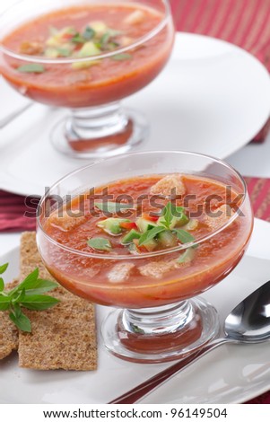 Two bowls of delicious cold Gazpacho soup with cucumber - avocado salsa. Good summer time appetizer.