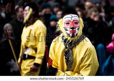 Paris, France - Jan 29, 2012: Chinese performers wearing monkey masks at the chinese lunar new year parade on January 29, 2012 in Paris.