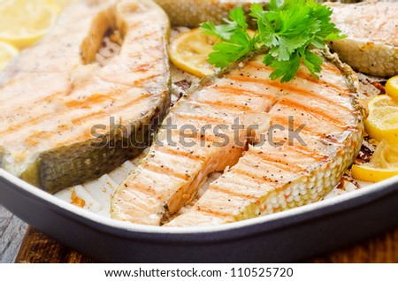 Cooking at home fresh salmon with lemon parsley
