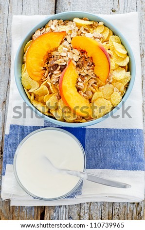 Bowl of cereal with muesli and fresh peach